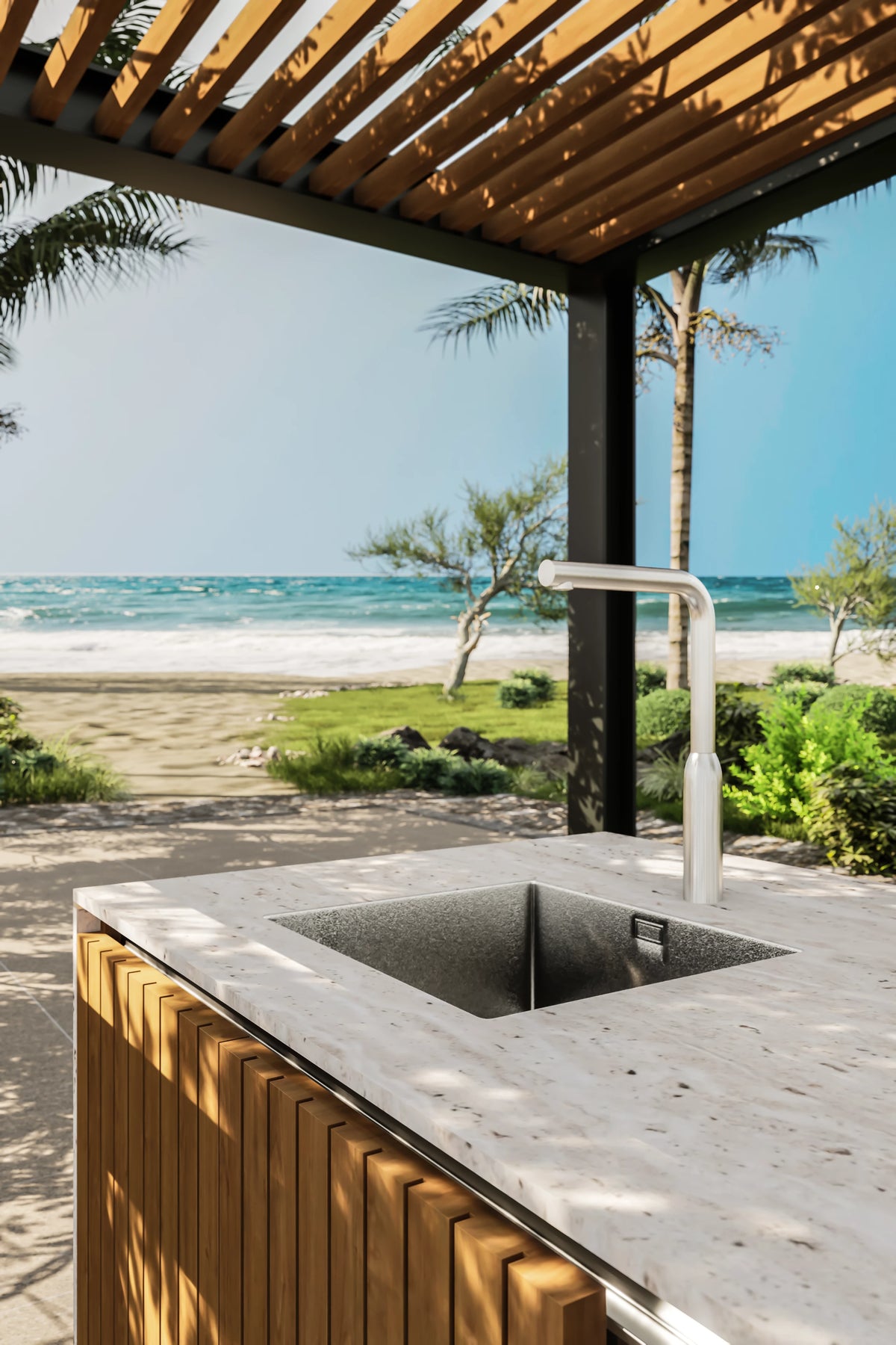 Built-in stainless steel sink and tall faucet set into the Al Fresco Kitchenette’s travertine countertop above teak cabinetry.