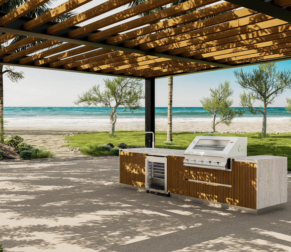Al Fresco outdoor kitchenette with teak cabinetry, a travertine countertop, built-in grill, sink and mini fridge beneath a pergola by the sea.