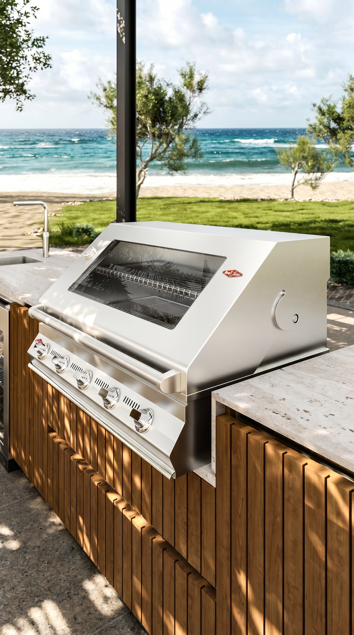 Close-up of the Al Fresco Kitchenette’s built-in stainless steel grill within a teak cabinet and travertine countertop configuration.