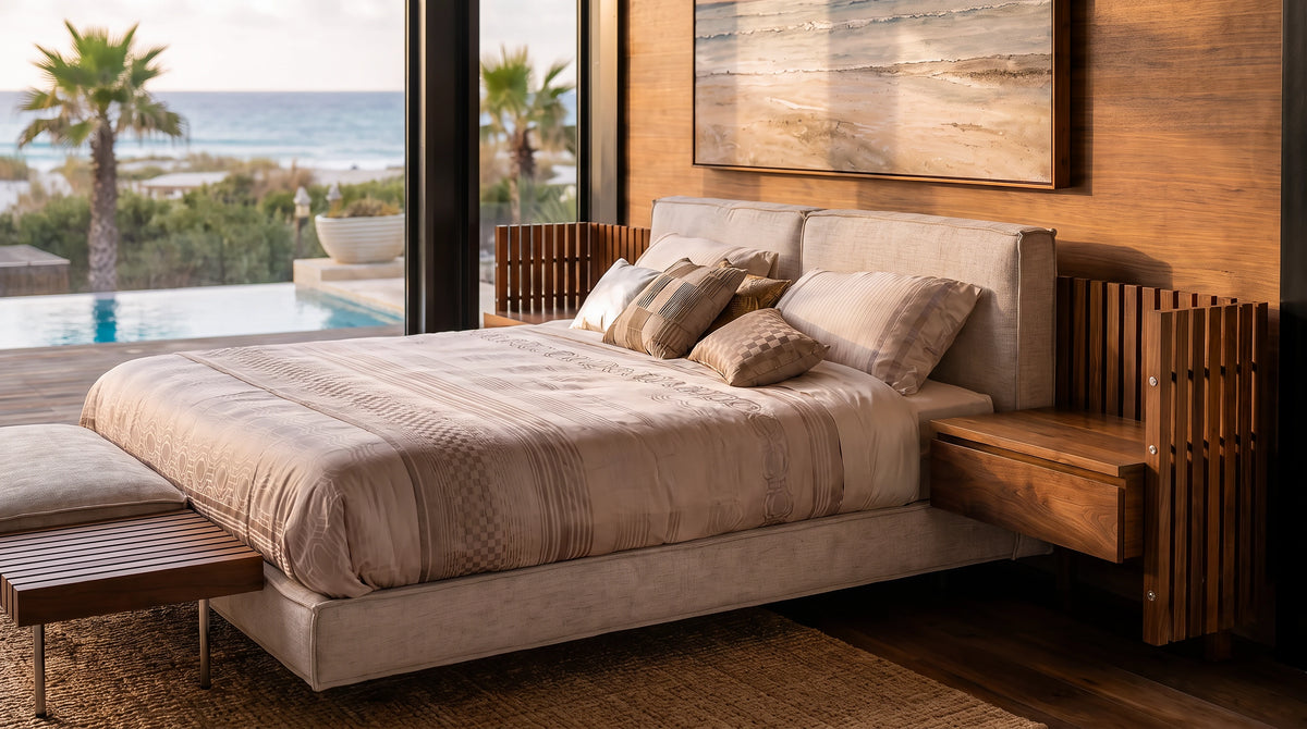 Angled view of the beige Da-Fluff bed with French seams, an extended wood slatted headboard, integrated side surface, and matching banquette.