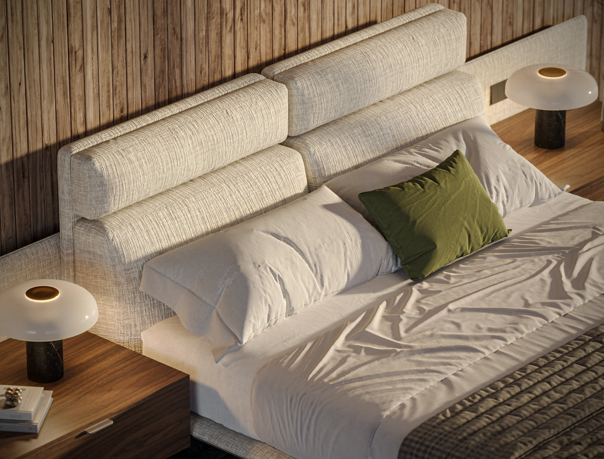 Close-up of the Chill bed showing two raised adjustable headrests, beige upholstery, and piping along the platform.