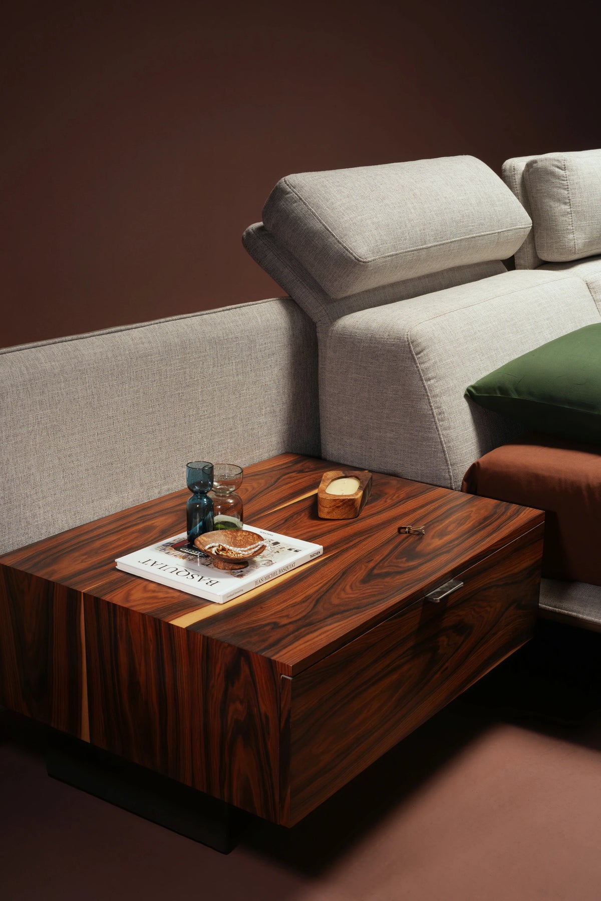 Close-up of Chill Bed showing upholstered cladding in grey upholstery with piping stitch detail.