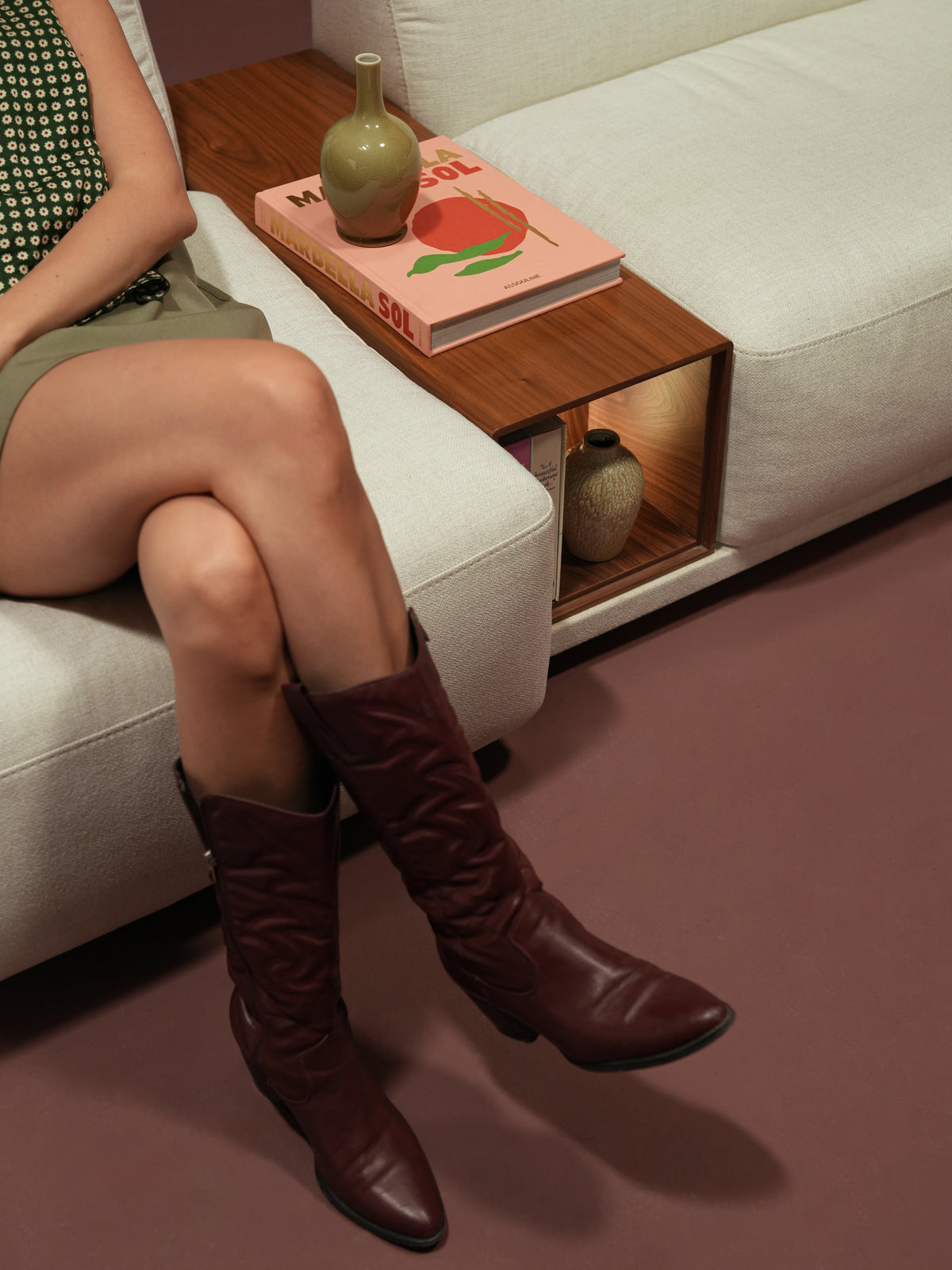 Close-up of the Chill sofa’s integrated wooden table with open storage between two ivory upholstered seats.