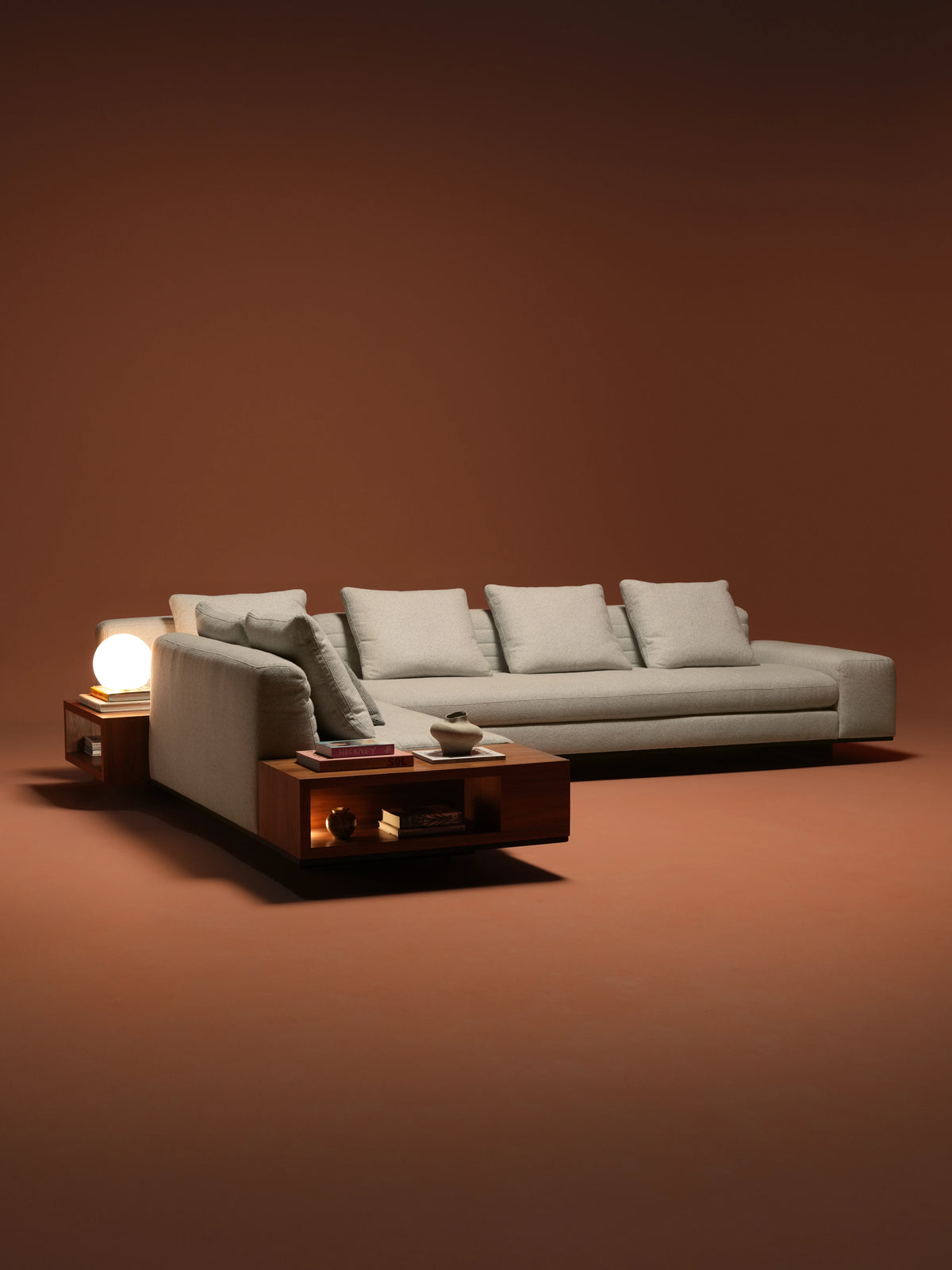 Beige Edge modular sofa with feather back cushions, inverted seam stitching, broad armrests, and integrated wooden side tables.