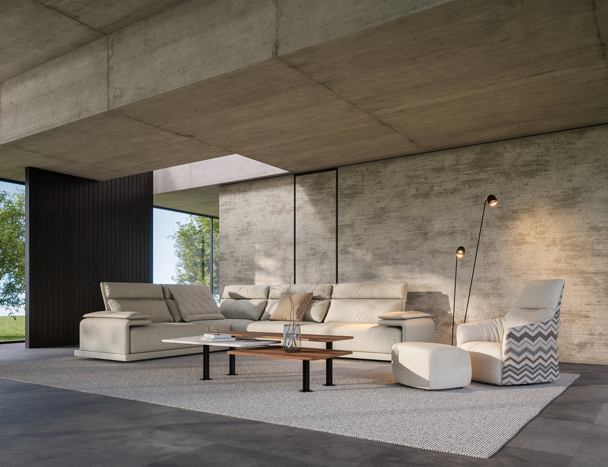 Angled view of a beige Flexor sectional sofa with adjustable headrests, a chaise longue, and lumbar cushions.