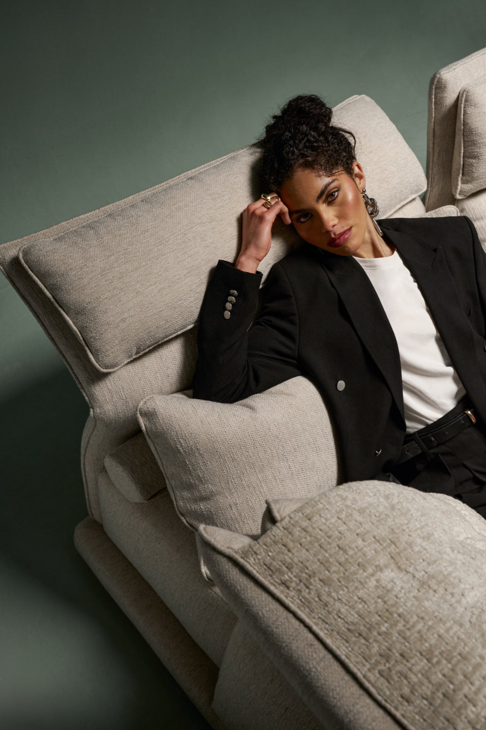 Flexor sofa with tilted headrest for relaxed lounging in beige fabric.
