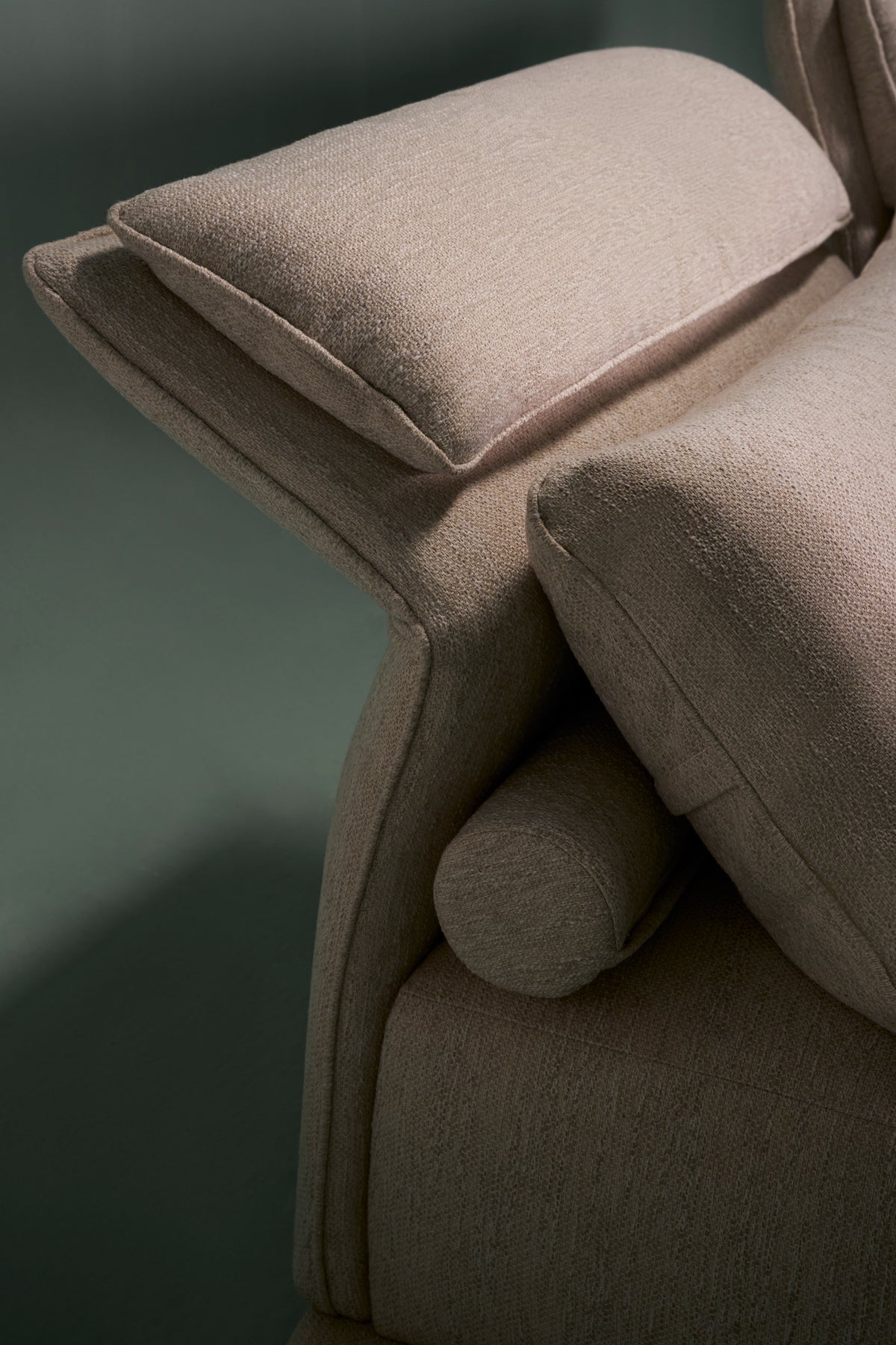 Side detail of Flexor sofa showing headrest titled with adjustable mechanism for flexible lounging.