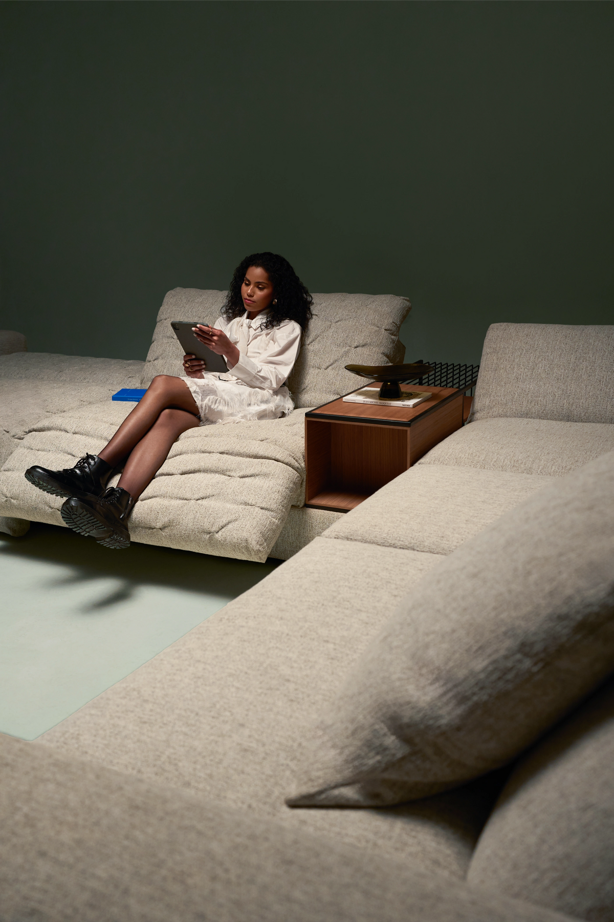 Side view of Lazy Nova sofa in grey fabric with adjustable headrest and reclining seat mechanism for customizable comfort.