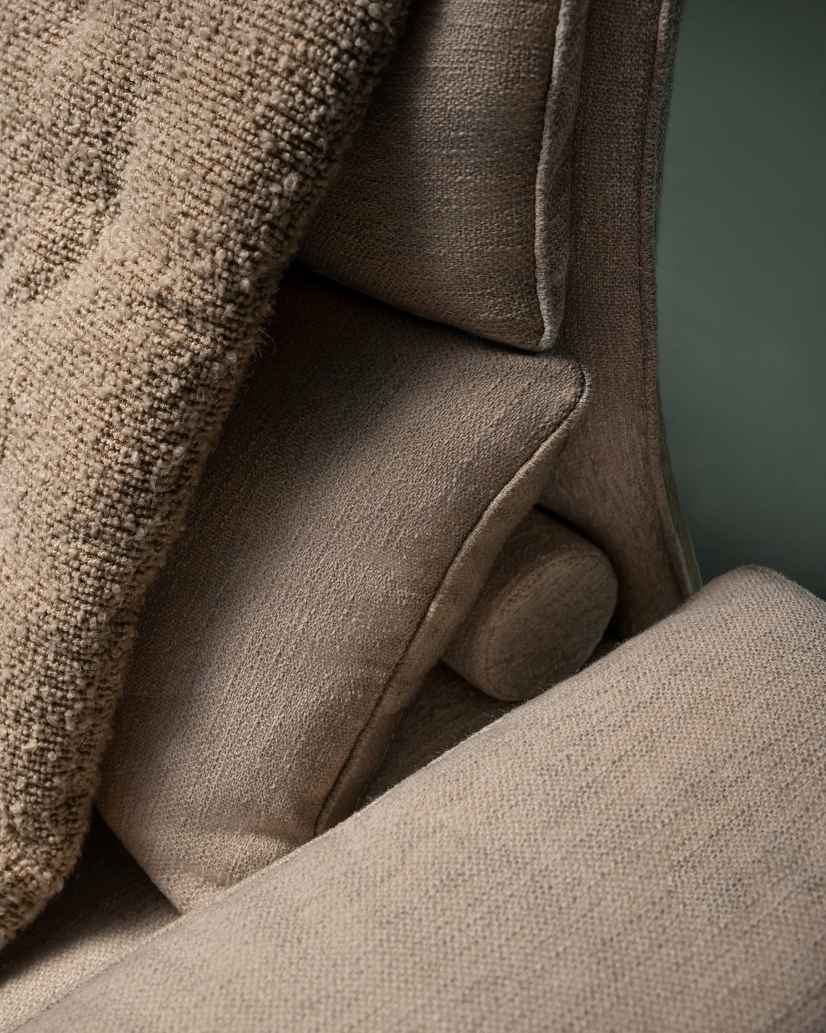 Close up of Flexor sofa fibre-filled back cushions with beige upholstery, and additional textured duvet.