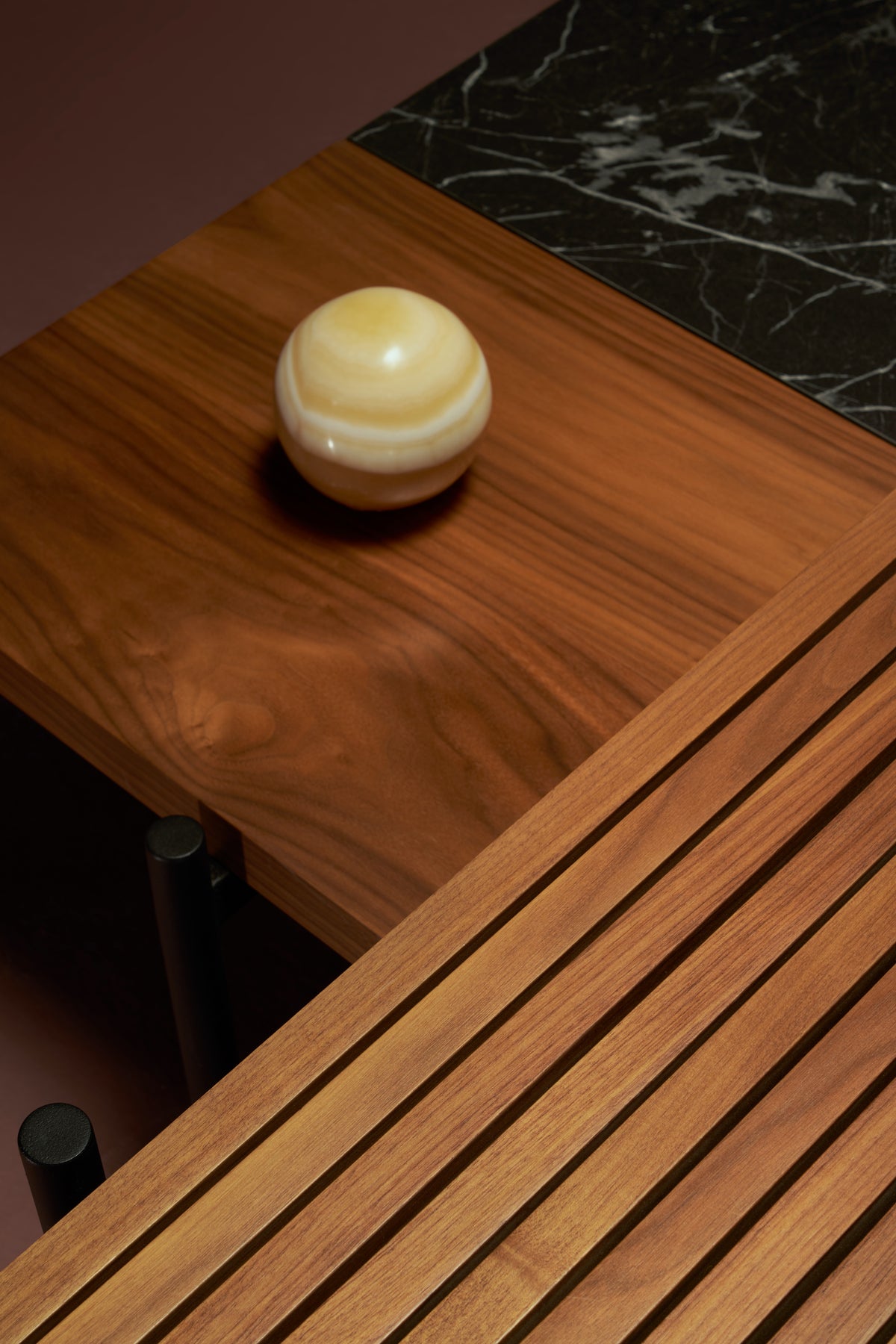 Close-up of Onyx dual-height coffee table showing ribbed solid wood slats on the raised upper layer intersecting the lower wood veneer and marble laminate base.