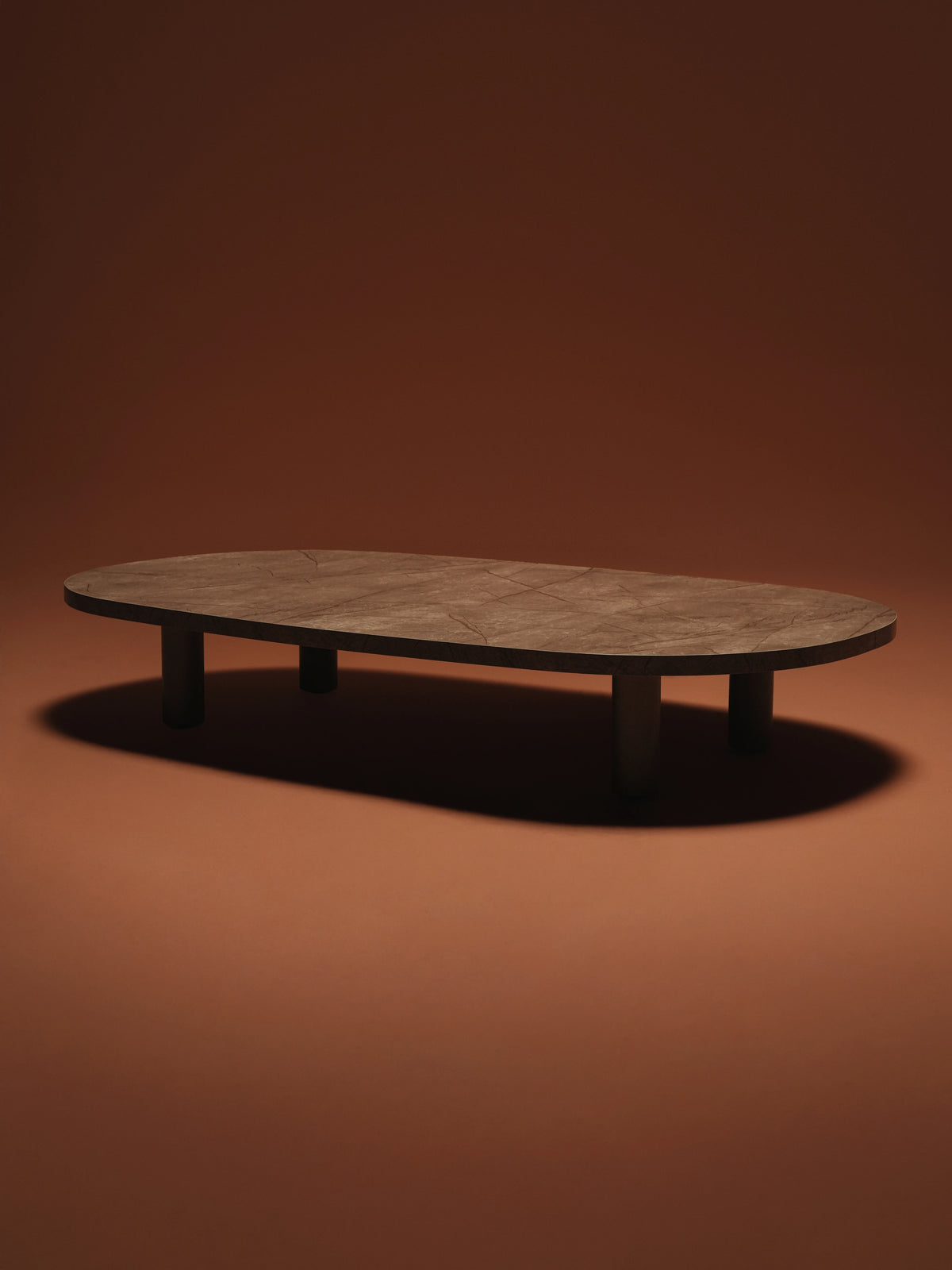 Opal coffee table with a rounded brown marble laminate top supported by round electrostatic-coated steel legs.