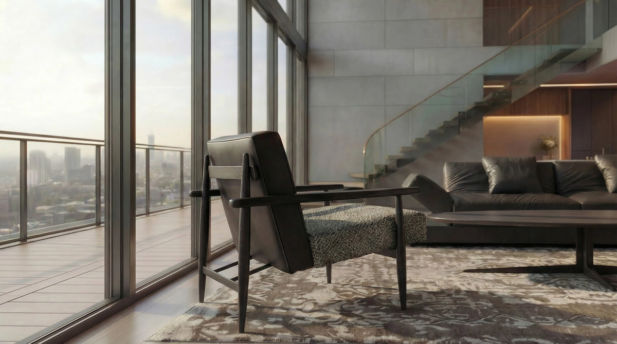 Retro Lounge armchair with a black leather backrest, textured grey seat, and dark wood frame in a modern living room with a city view.