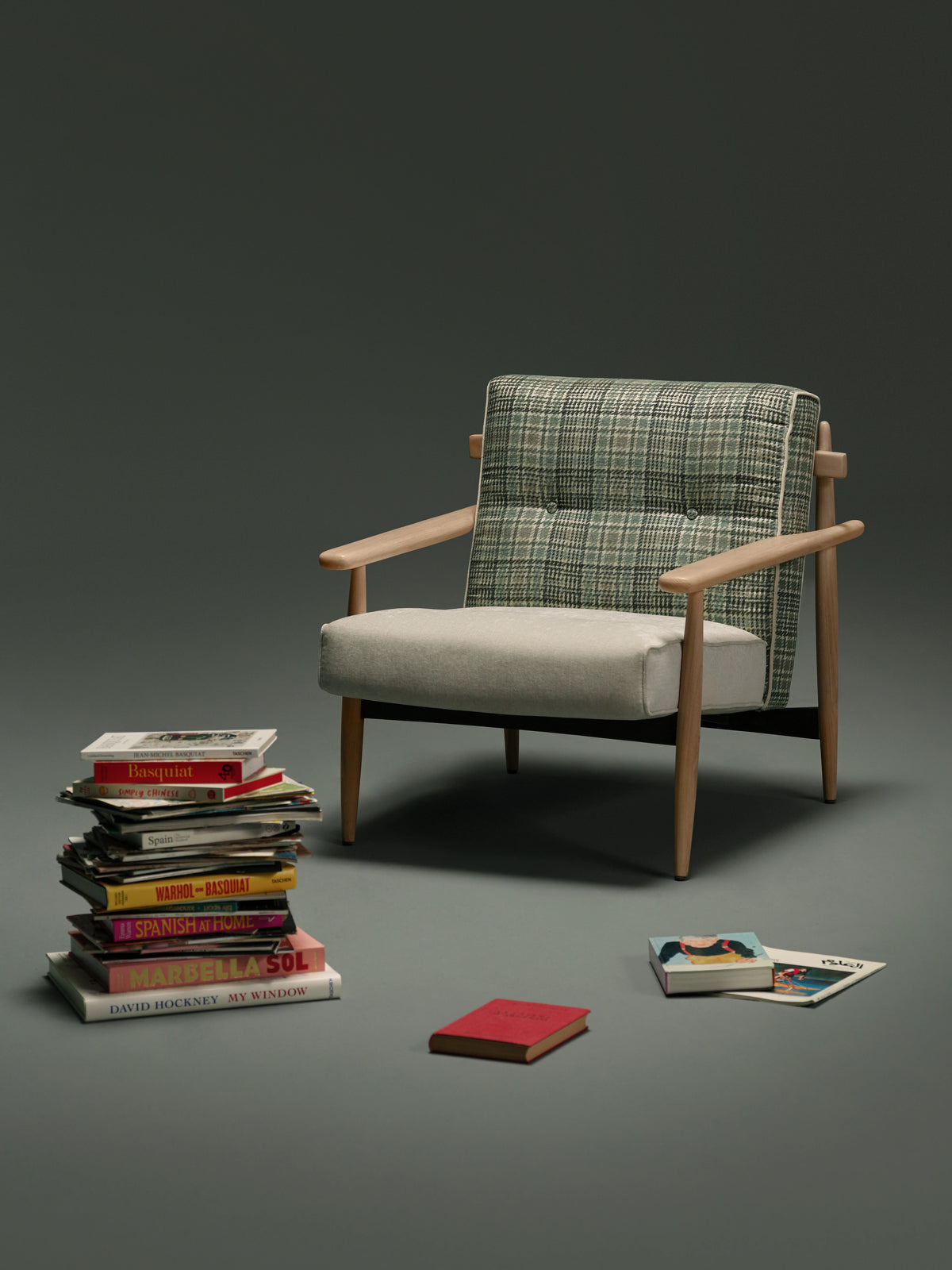 Front view of the Retro Lounge armchair with a plaid capitonné backrest, light upholstered seat, curved wooden armrests, and solid wood frame.