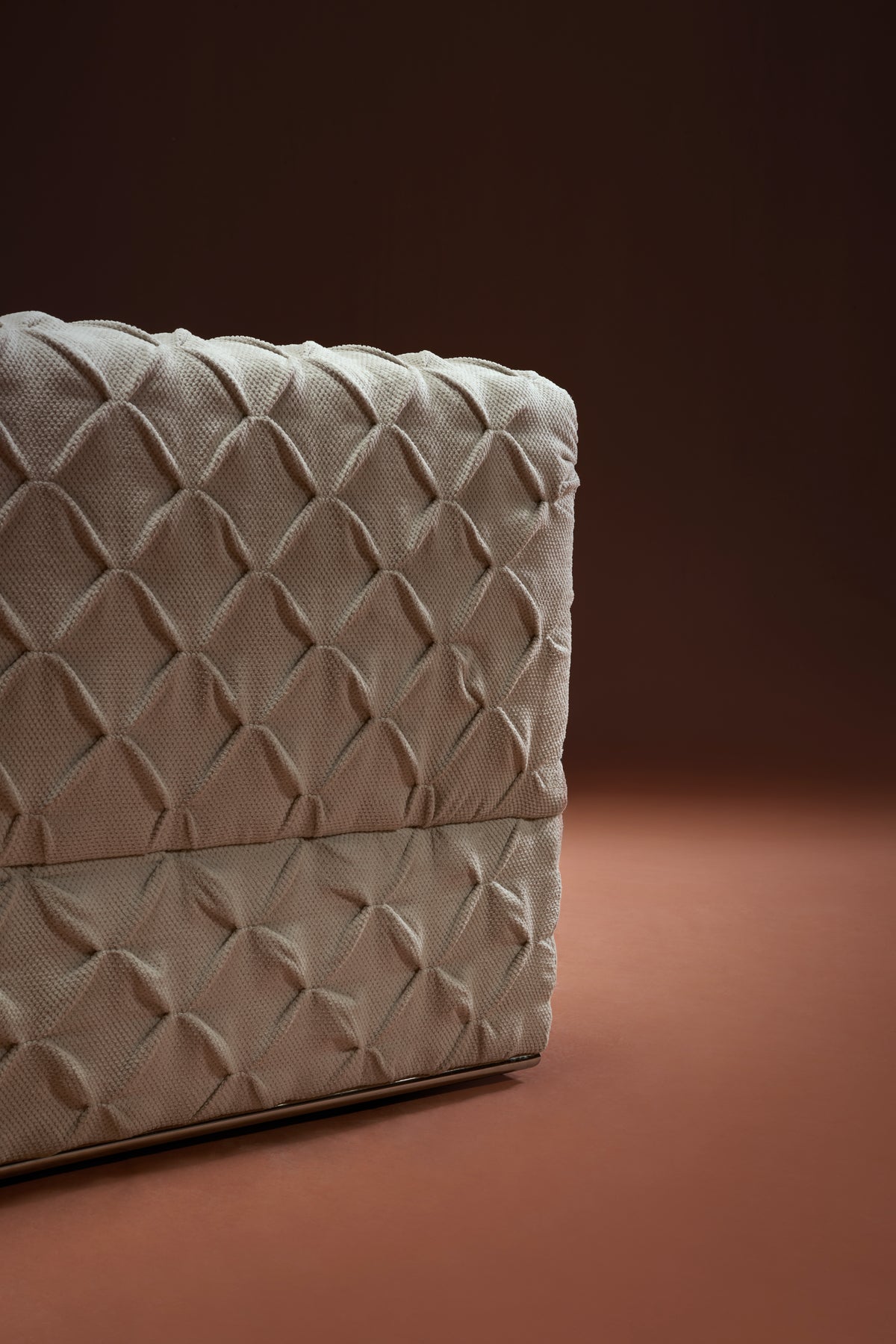 Back view of Ro-Blocks bed in cream fabric with continuous pinch-pleated upholstery across the frame.