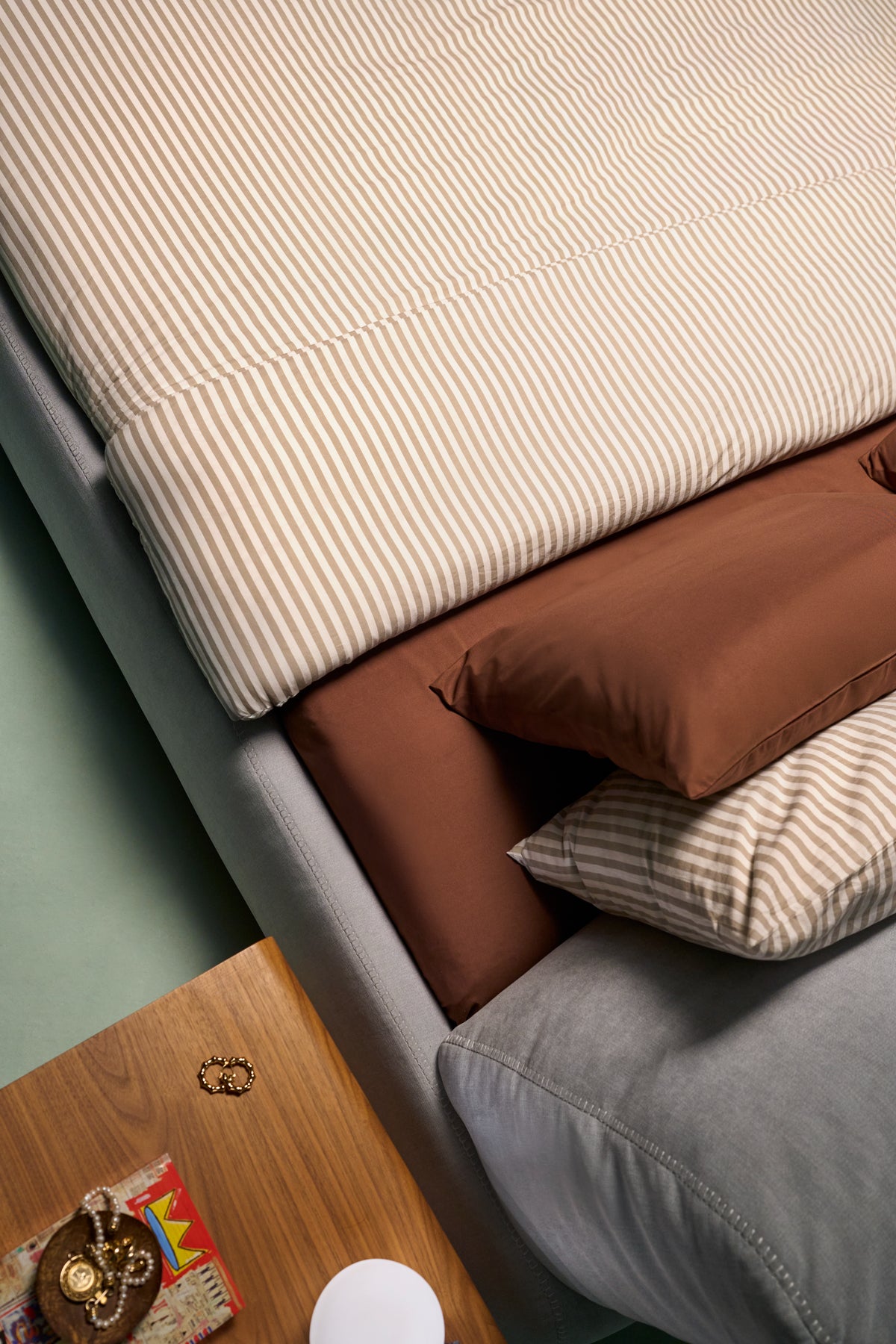 Close-up of Snug Bed showing recessed mattress frame with overcast stitching on frame and backrest edges.