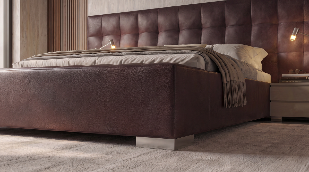 Close low-angle view of the Square bed’s burgundy banquette and square tufted upholstered cladding.