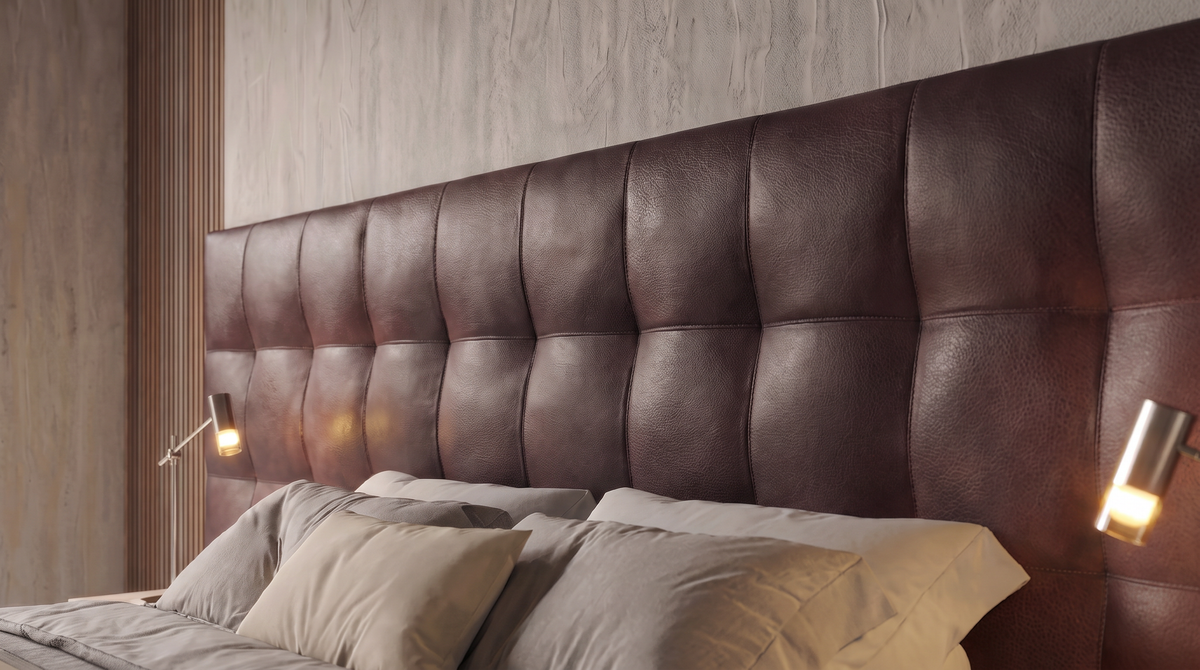 Close-up of the Square bed’s dark brown upholstered grid cladding with horizontal and vertical stitched seams.