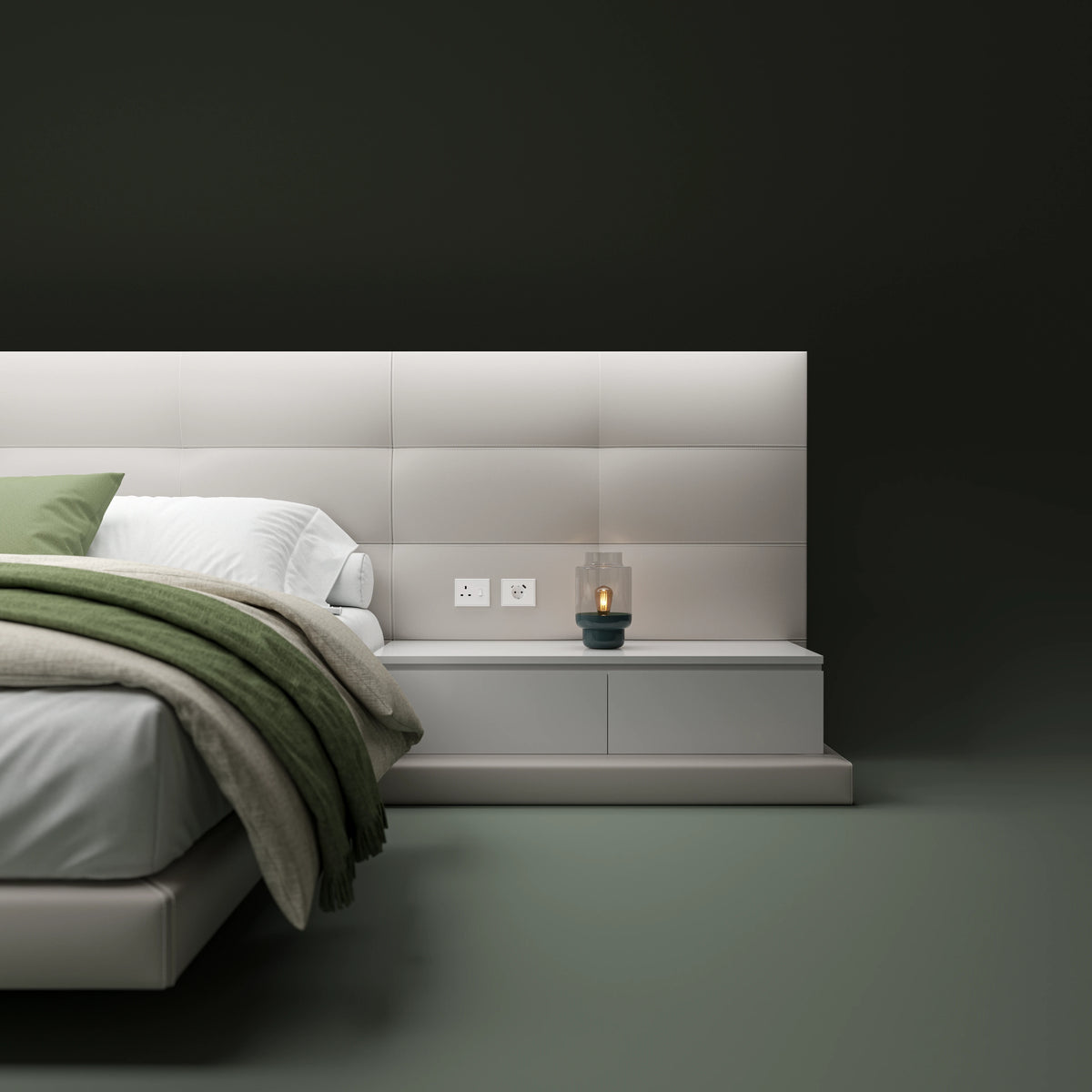 Close-up of the Sublime bed’s beige tufted cladding and integrated nightstand with a padded partition and built-in outlets.
