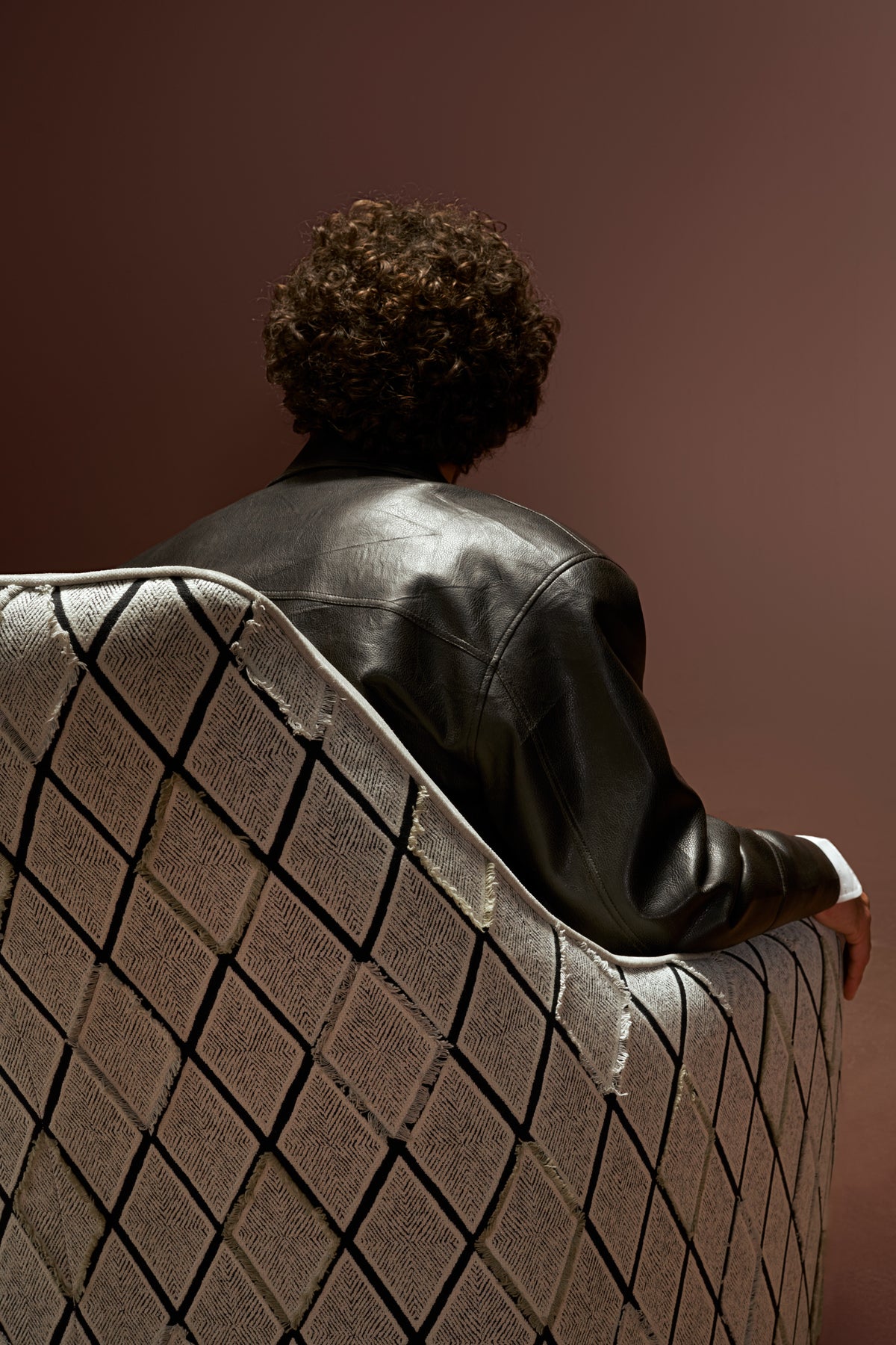 Back view of Windsor High Armchair with tall backrest and stitched diamond-patterned upholstery in beige fabric.