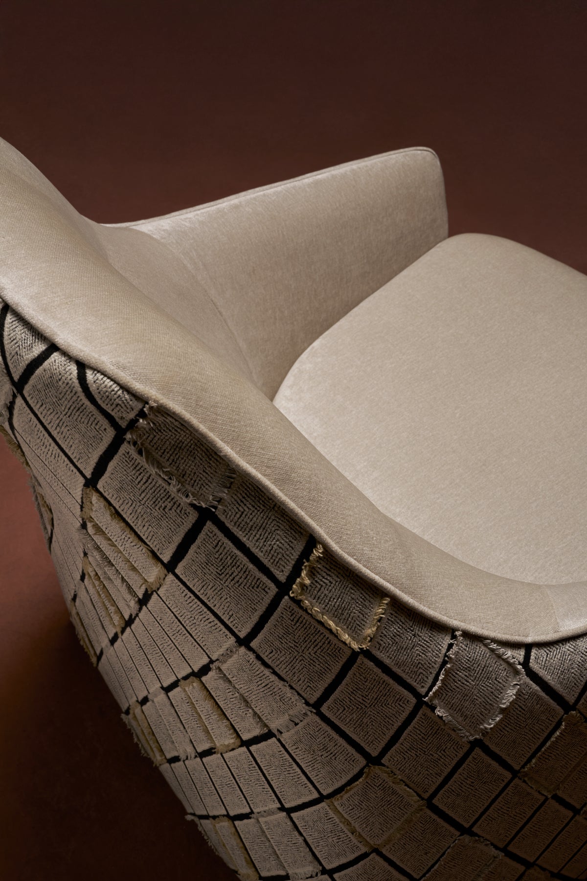 Close-up of Windsor High Armchair with diamond-stitched side panel, cushioned beige seat, and frame tube-stitching detail.